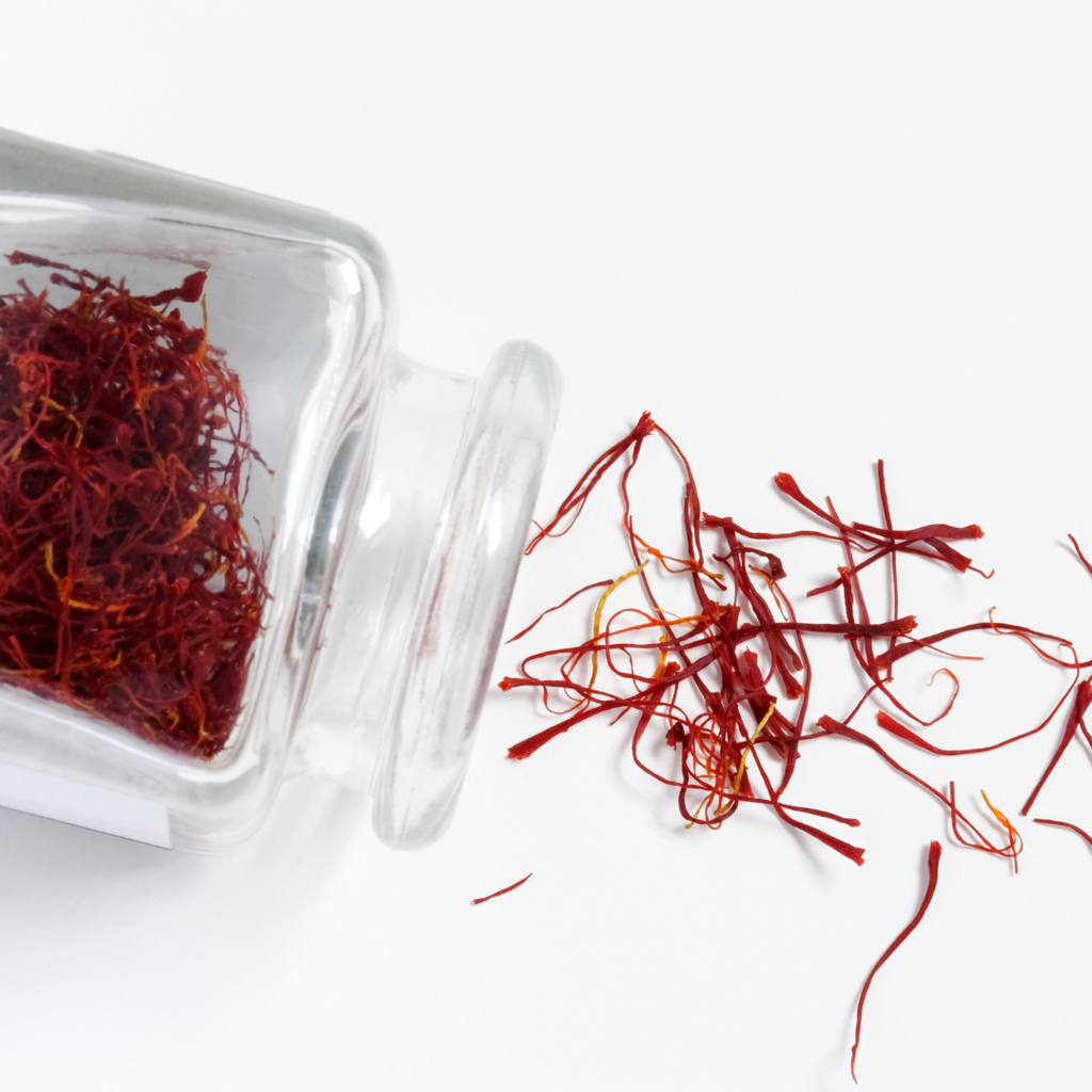 A jar filled with dried saffron, a valuable spice known for its vibrant color and distinct flavor.