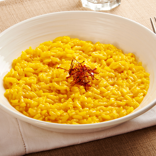 bowl of saffron rice garnished with saffron threads