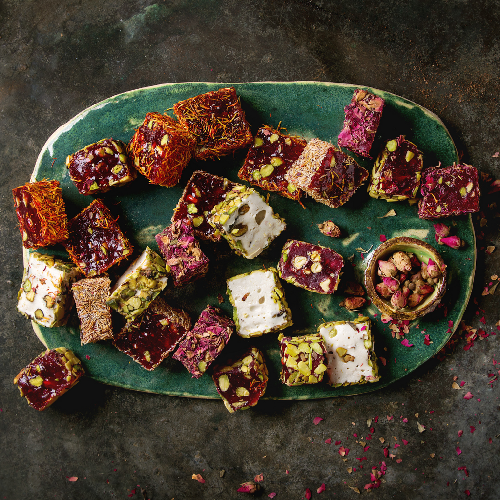 chopped turkish delight of different flavors on a blue ceramic plate